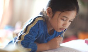 Young Asian girl reading
