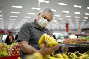 Man with mask in a supermarket